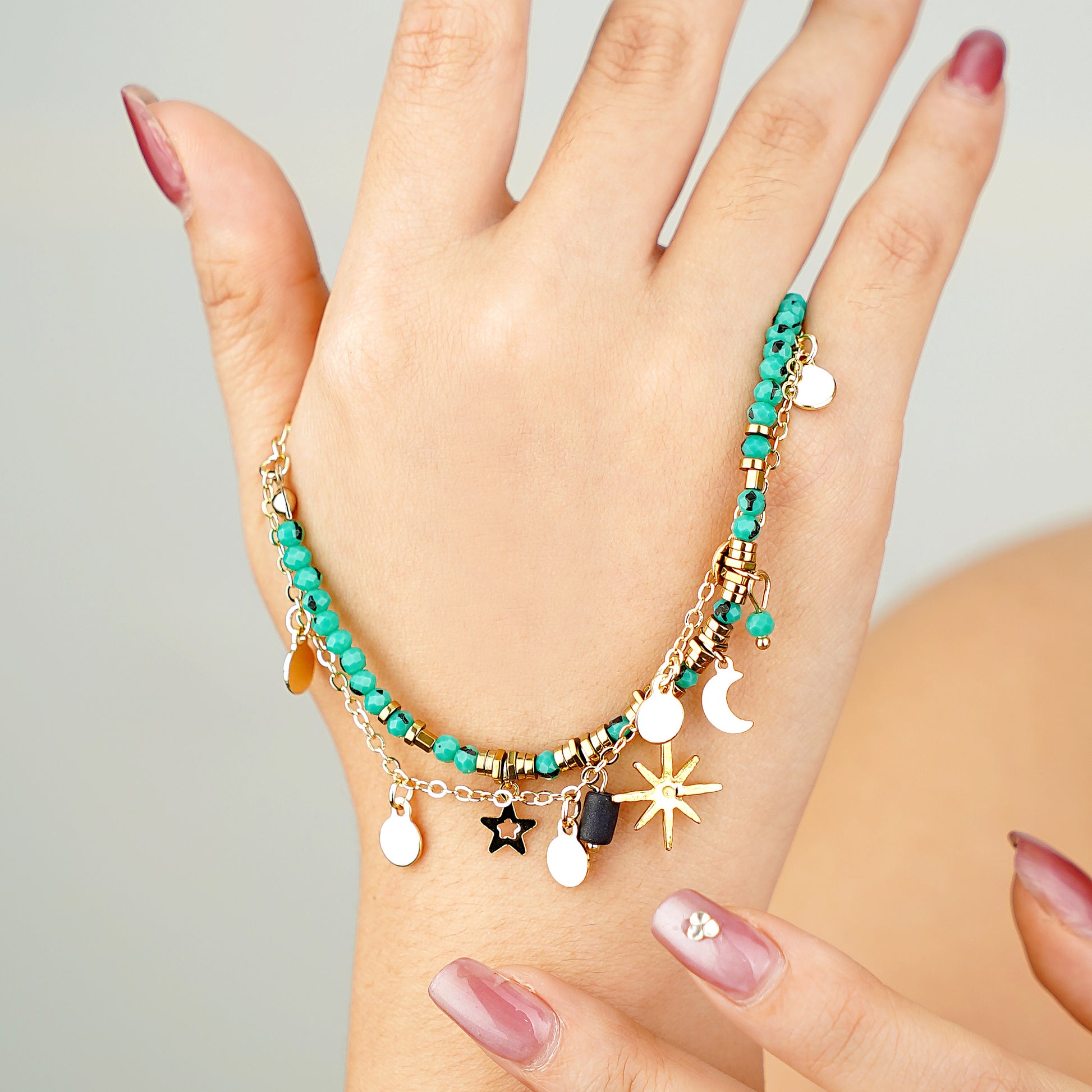 yellow gold plated celestial charm bracelet with blue turquoise beads