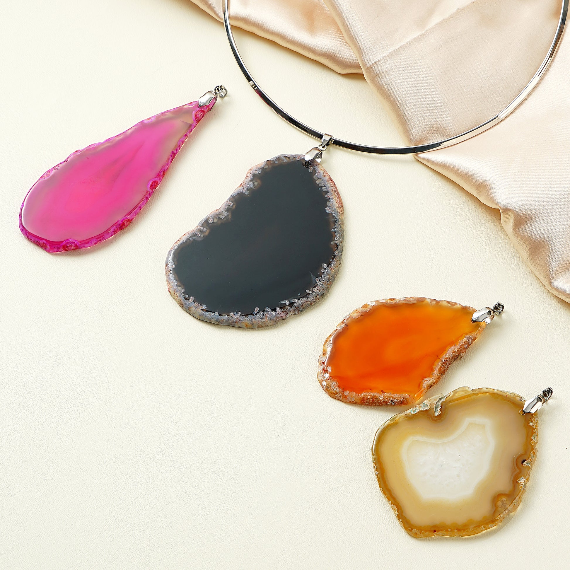 Set of colorful agate pendants on a light background