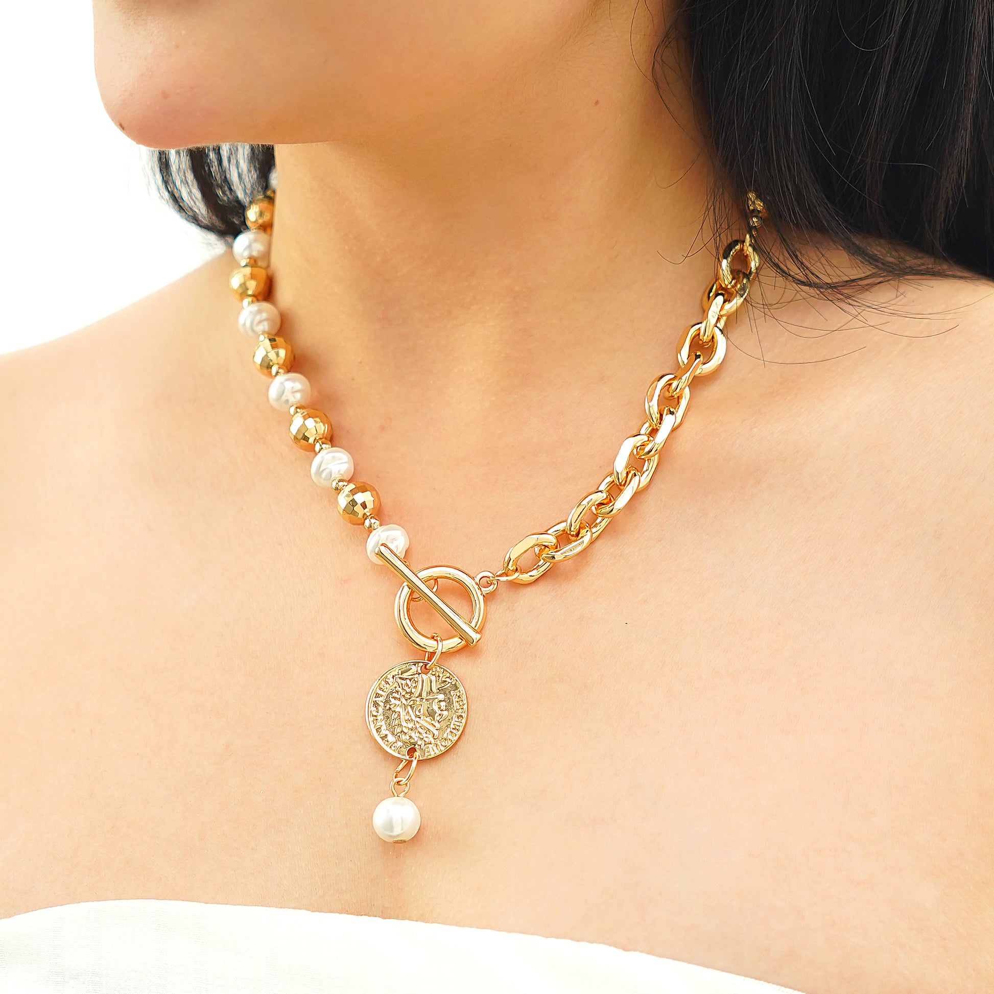 designer coin pendant necklace with pearl charm and front T-bar toggle clasp in yellow gold