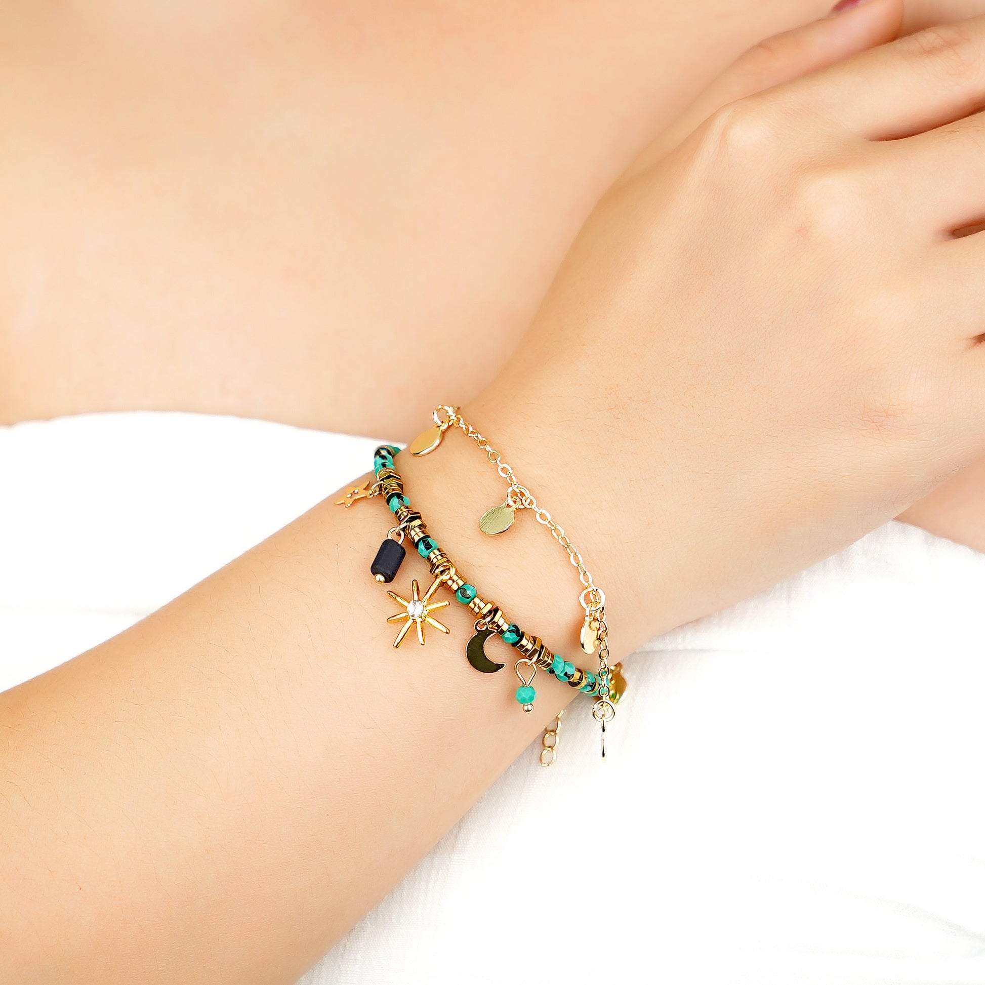 yellow gold plated celestial charm bracelet with blue turquoise beads