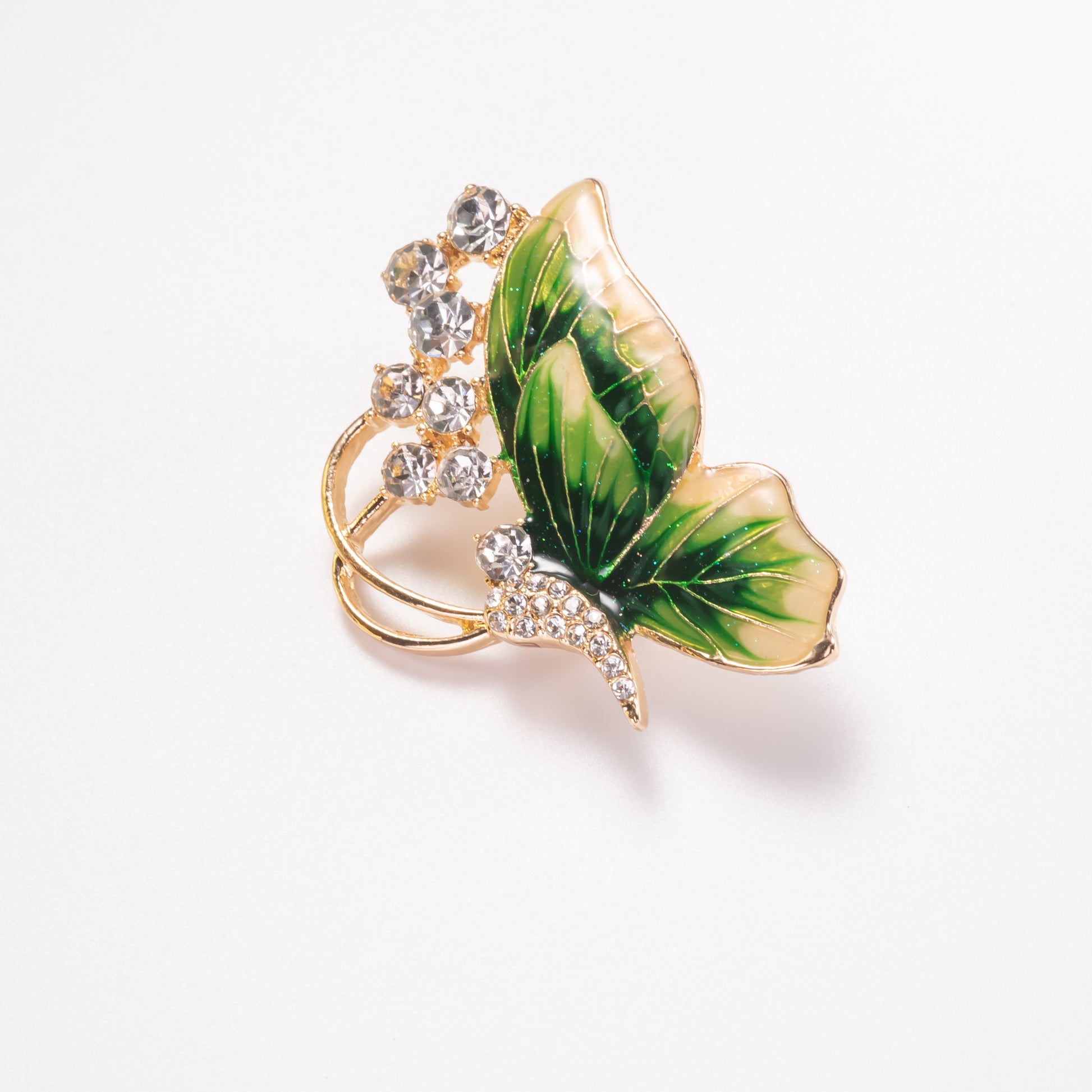 Butterfly-shaped brooch with green wings and gold accents