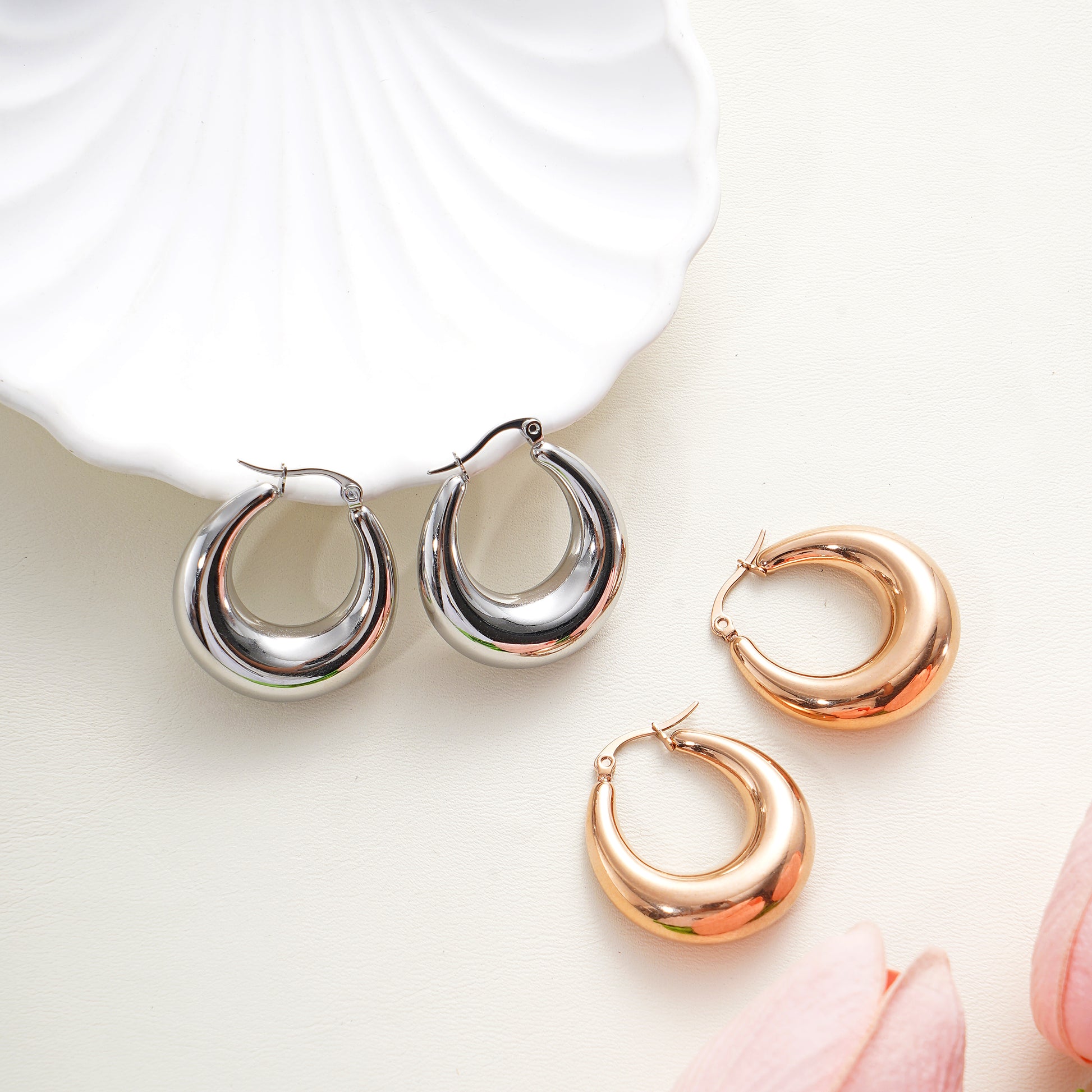 pairs of hoop earrings in silver, rose on a light background.