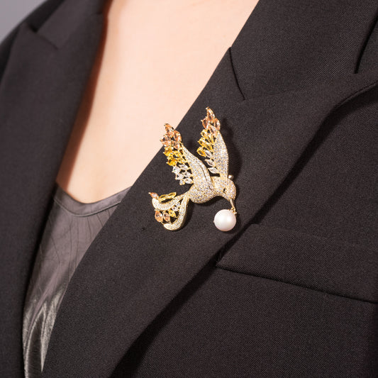 gold dove brooch pinned to a navy blue blazer lapel