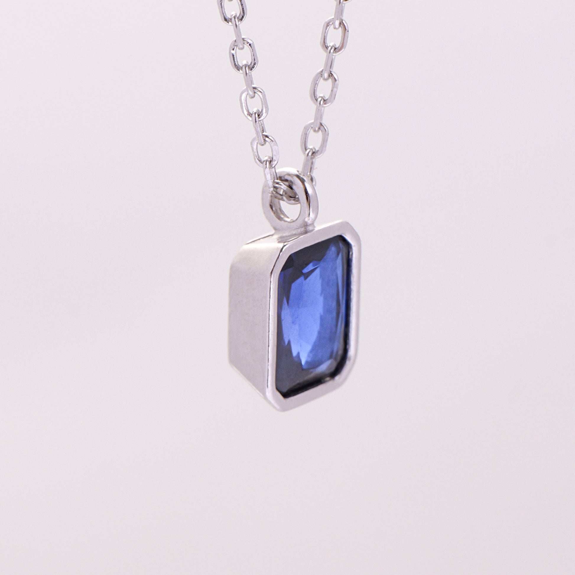 Octagon-cut clear CZ solitaire pendant in a polished silver bezel setting on a sterling silver chain