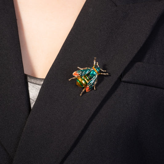 Colorful beetle brooch on a black blazer