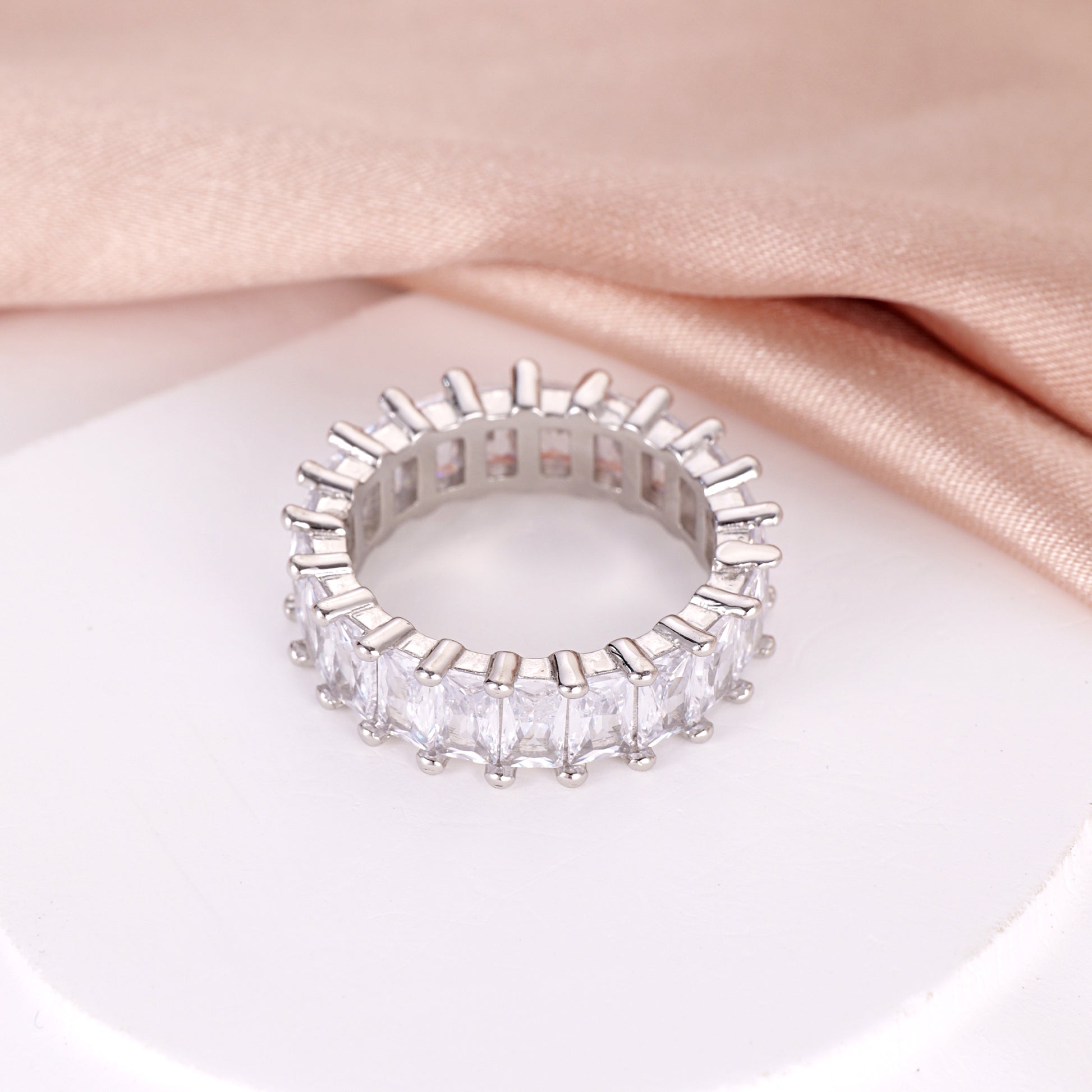 octagon-cut stones and 925 silver setting on an eternity band ring