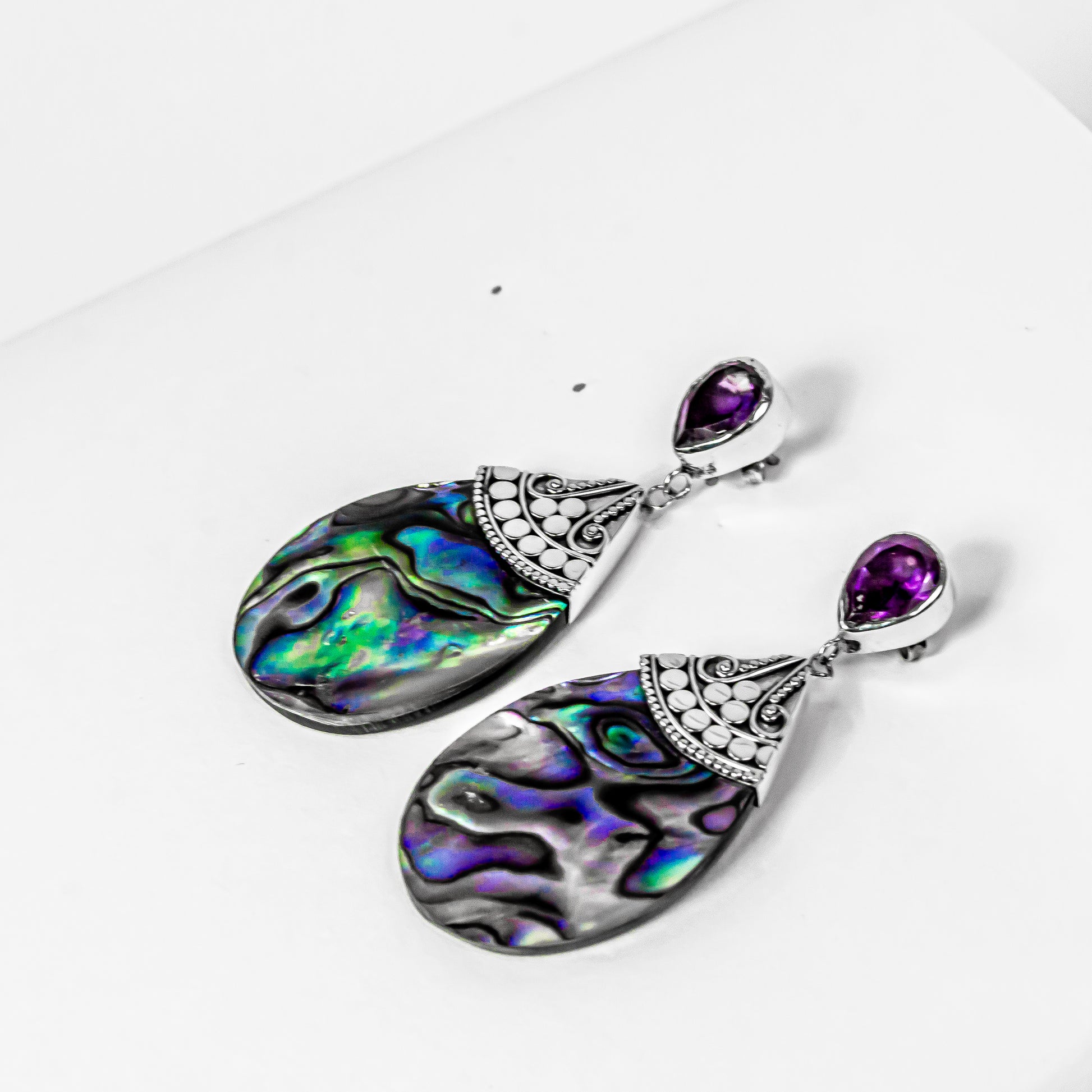 silver filigree surrounding an iridescent abalone shell inlay