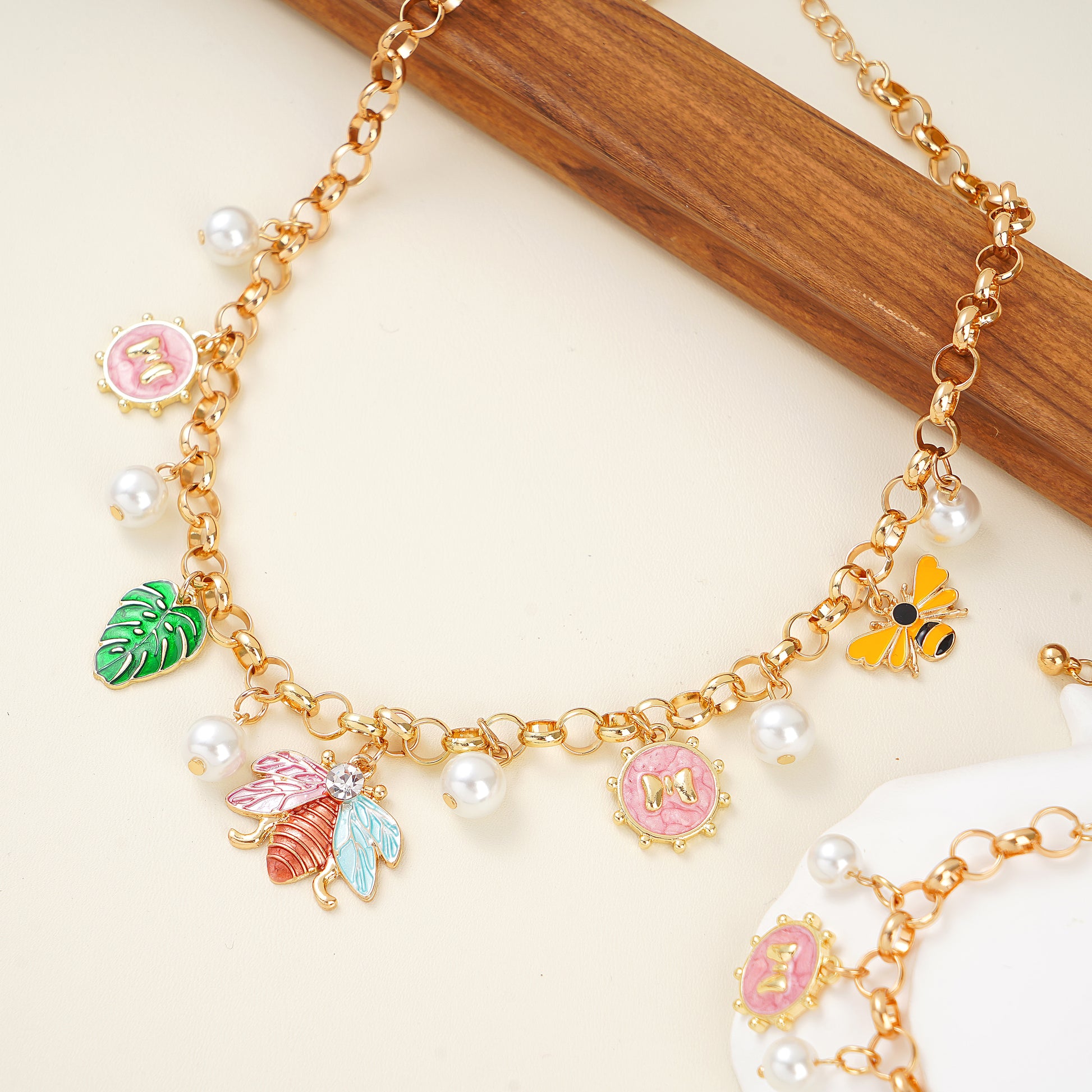 spring nature inspired charm necklace and bracelet set in yellow gold plated brass