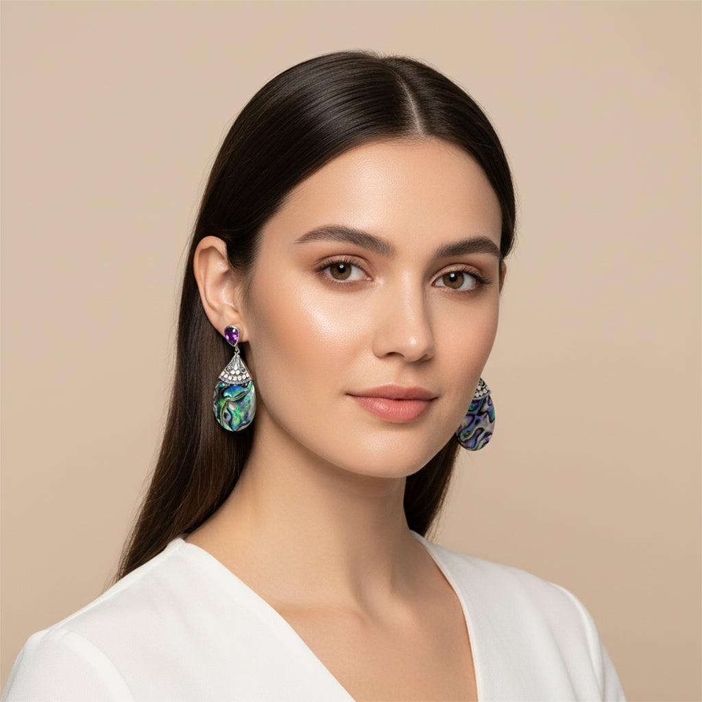 Woman wearing elegant earrings against a beige background