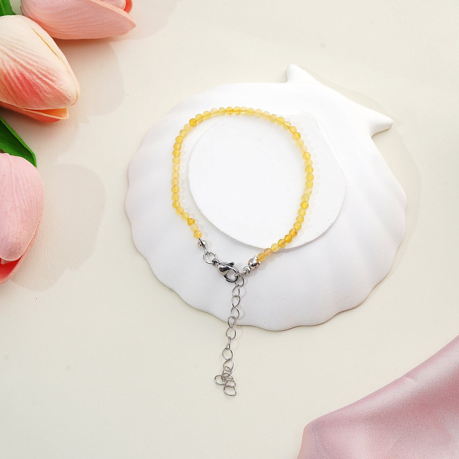the faceted yellow opal beads showing the honey-colored variations and diamond-cut sparkle