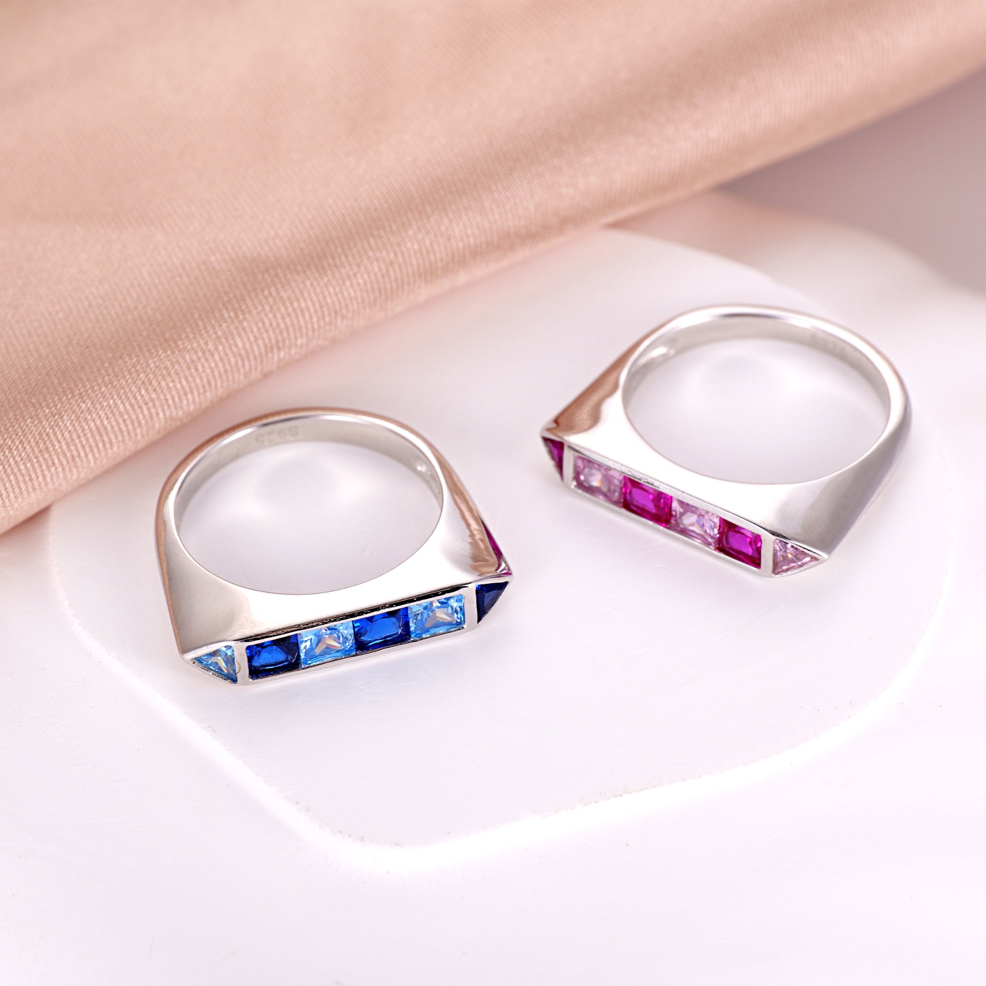 the geometric vintage setting and the contrast between the deep blue and light aqua gemstones