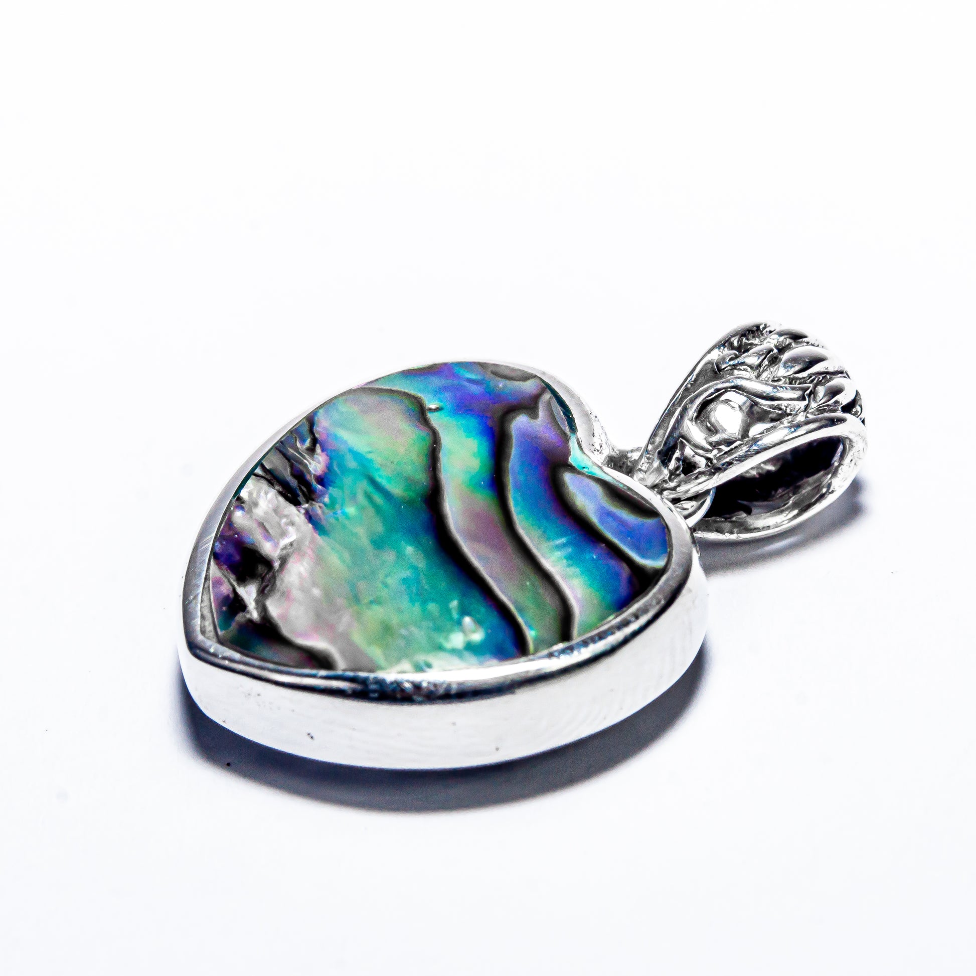 the handcrafted Balinese silver scrollwork on the edge of the abalone heart pendant