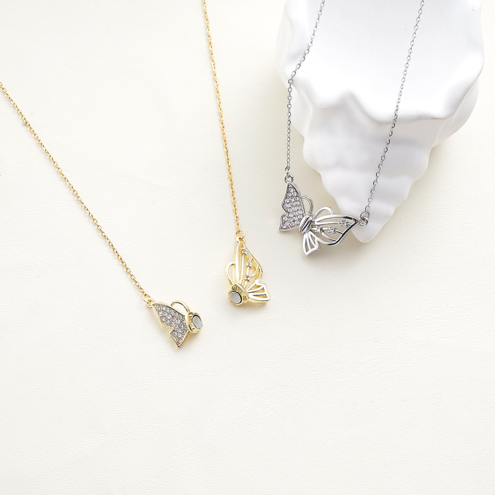 the magnetic butterfly pendant showing the sparkling simulated diamond details