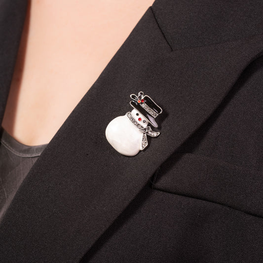 the shimmering crystals and polished silver-tone finish on the snowman holiday pin