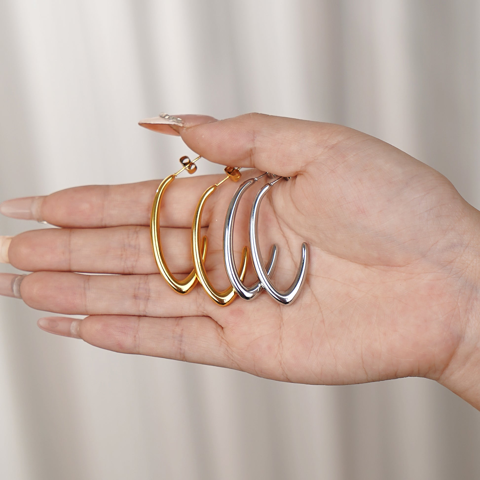 the sleek open J-shape hoop earring design in polished gold finish