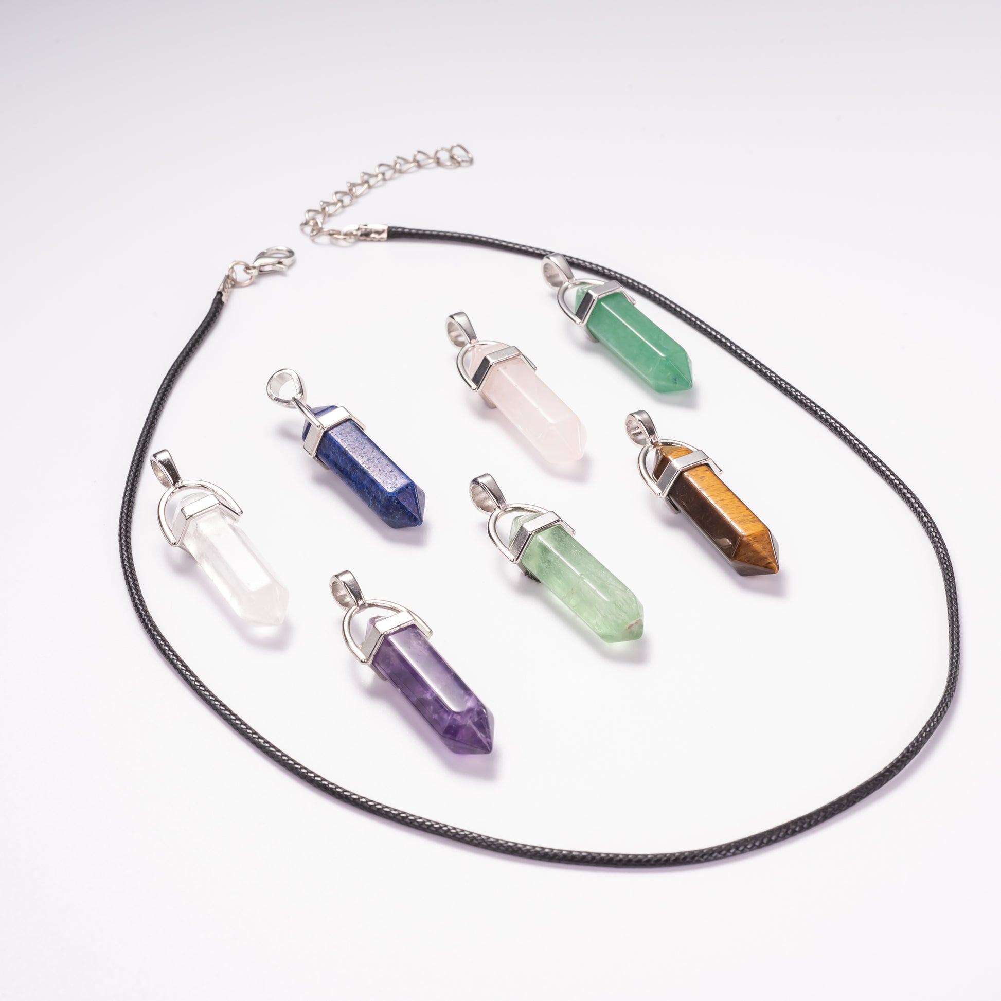 Necklace with various crystal pendants on a white background